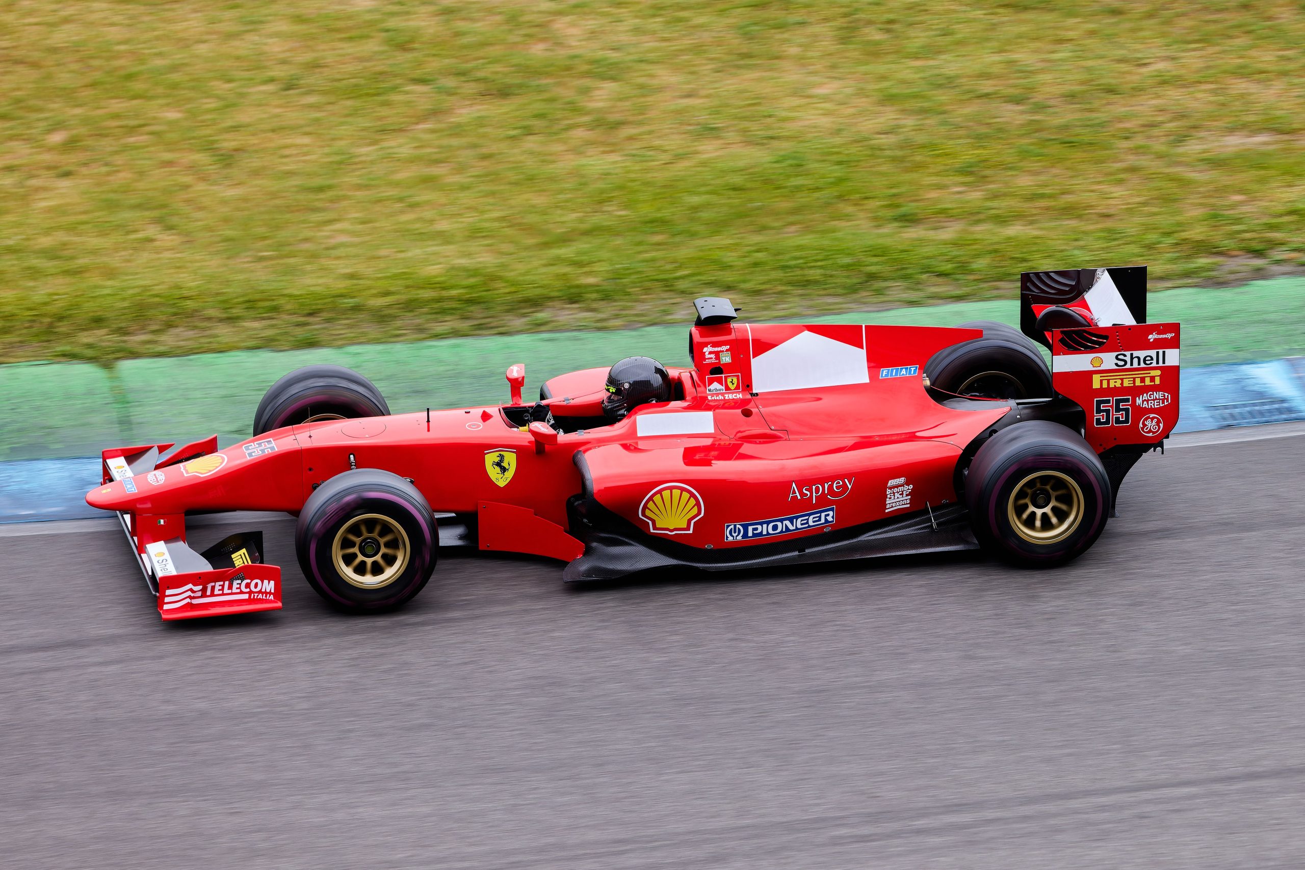 High-speed Formula 1 car in action on an outdoor racing track, showcasing the engineering and aerodynamic performance of F1 machinery