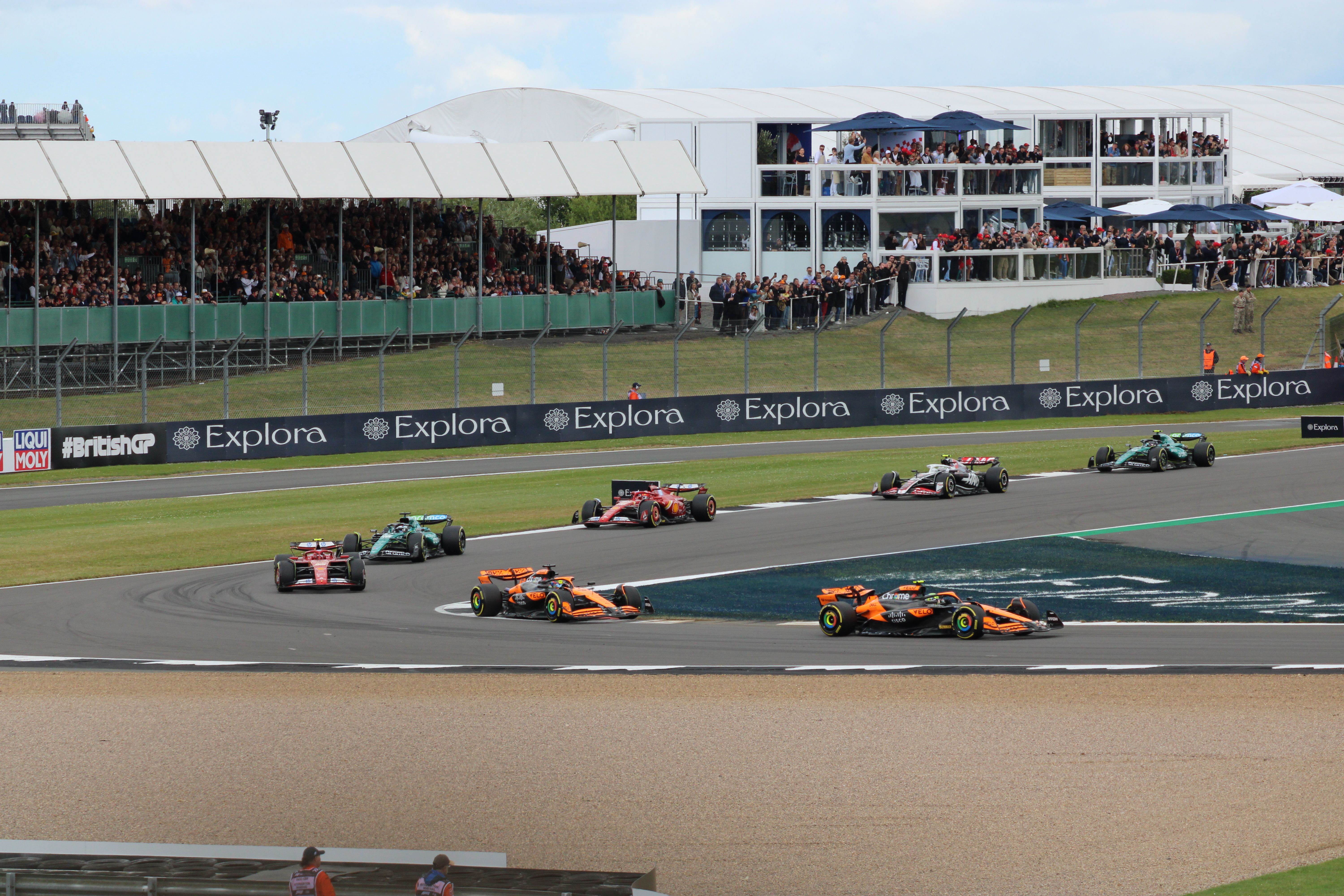Packed grandstands and crowd watching a race at Silverstone Circuit in England